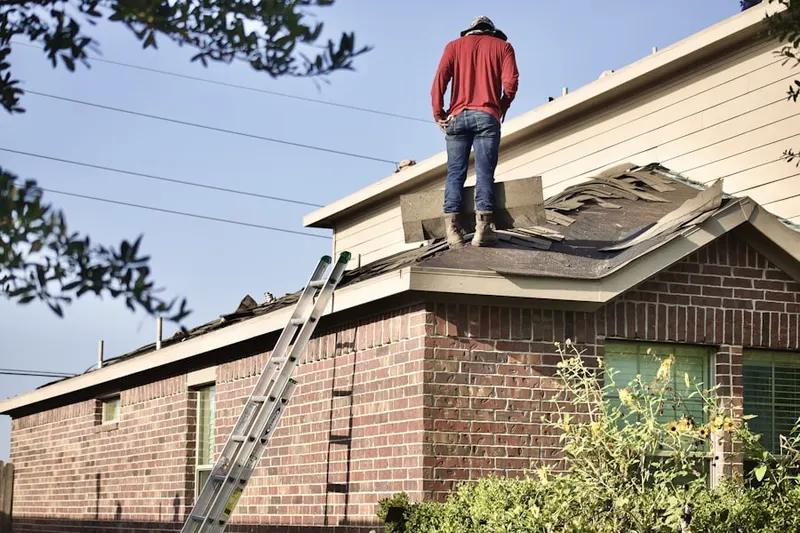 Professional roofer working on a residential roof in Misty Meadows